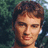 Pixelated image of a person with brown hair against a green background, surrounded by green text on a yellow field.