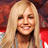 Pixelated static image of a smiling person with long blonde hair against red and dark background elements.