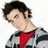 Pixelated image of a person with dark hair wearing red and gray clothing against white background.