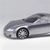 Pixelated grayscale image of a car's front section with visible headlight, wheel, and side mirror against a light gray background.