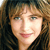 Pixelated close-up of a person's face with brown hair and light skin, static single-frame image.