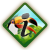 Diamond-shaped icon with green border showing person in yellow shirt holding black microphone against blue sky and green grass background