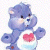 Static pixelated icon of a blue Care Bear wearing a white shirt with a red heart symbol on the chest, standing against a transparent background.