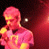 Two figures in red-toned stage lighting with text reading 'staying up late' below, one figure holding a microphone.
