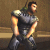 A 4-frame animated contact sheet showing a muscular character in dark armor with shoulder pads, performing a side-to-side motion against a brown background.