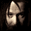 A static image of a person's face with three showing text below: BLACK, IS, BACK