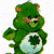 Static 50x50 pixel icon of a green Care Bear with a white belly patch featuring a dark green shamrock symbol, standing upright against a transparent background.