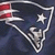 Pixelated icon featuring a stylized football helmet with red and white stripes on the left side, set against a dark blue background.