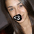 A pixelated image of a person with long dark hair holding a black and white object near their mouth, next to text reading 'what more could i ask for?' in bold block letters.