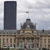 A pixelated static image shows a historic building with a domed roof and a tall dark tower against a cloudy sky.