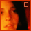 A pixelated close-up of a person's face with warm orange and red tones, showing two with a square symbol changing from outlined to filled