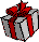 Pixelated gift box with red ribbon and orange teddy bear emerging from it, shown in three