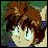 A pixelated anime-style character with brown hair and green eyes on the left, next to a black background with white text "Anime IM" above smaller stylized text "c0m" on the right.