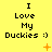 Yellow background with repeated text "I Love My Duckies :)" in black pixelated font, each instance accompanied by an orange symbol below.