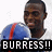 A person in a white shirt holds a blue football helmet with red stripe, displaying text and symbols