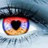 Pixelated close-up of a human eye with multicolored iris, dark eyelashes, and visible eyebrow above.