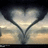 A heart-shaped composition formed by two dark curved lines against a gradient sky background with light and dark horizontal bands.