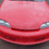 Red car with silver accents and 'z24' text on black background, animated sequence showing partial white light effect on right side.