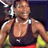 Pixelated static image of a muscular person in athletic wear holding a tennis racket, with visible shoulder straps and red shorts.