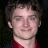 A pixelated image of a person with short brown hair wearing a red shirt, next to green text reading 'OriginalIcons.com' on a dark background.