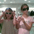 Two pixelated figures in a static image, one wearing dark sunglasses and a gray top, the other in a light pink sleeveless dress with arms crossed.