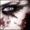 Close-up of a pale-skinned face with dark smudged eye makeup, a blue eye with a vertical slit pupil, and red smears resembling blood on the cheek and nose.