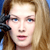 Pixelated close-up of a person with light brown hair and blue eyes, static single-frame image.