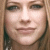 A pixelated image of a person with light brown hair and fair skin, next to a white square containing the text 'avril' in dark blue lowercase letters.