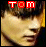 Two side-by-side pixelated images of a person's face with red 'TOM' text above, showing subtle differences in facial expression and color tones.
