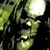 Pixelated static image of a green-skinned cartoon character with glowing eyes and mouth, set against dark foliage under a bright light source.