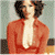 A pixelated image of a person in an orange jacket with dark hair, next to green text reading 'Original Icons .com' on a dark background.