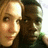 Two people pose closely together in a pixelated image with visible color shifts