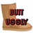 Pixelated brown boot with red text reading "BUTT UGGY" overlaid on top, set against a white background.