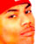 Pixelated close-up of a person's face with red headwear, orange skin tones, and visible eyes and mouth against a white background.