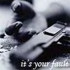 A grayscale image shows a person lying on their back with legs bent and arms raised, overlaid with text reading "it's your fault" at the bottom.