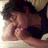 A person with dark hair rests their head on folded arms, eyes closed, in a sequence of showing subtle shifts in posture and lighting