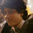 Pixelated image of a person with dark hair and brown skin on left, green background with pink text reading 'I Love... Nick Jonas' on right.