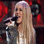 A pixelated image of a woman singing into a microphone with long blonde hair, alongside four people posing together and a 'Hannah Montana' logo on a checkered background.