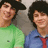 A pixelated image of a person in green and blue shirts with red tie, showing slight variations