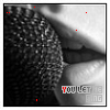 A black-and-white close-up of lips with a textured surface, featuring animated colored dots and plus signs moving across the image, with text at the bottom reading "YOU LET ME SING" in varying colors.