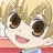 Pixelated close-up of an anime-style character with blonde hair, large brown eyes, and a pink mouth, wearing a red garment.