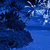Pixelated blue landscape with dark rock formations and white snow-like patterns, featuring a light blue text box reading 'Paradise' on the right side.