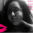 Pixelated grayscale portrait of a person with dark hair, pink lips, and a pink background element on the right.
