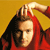 A pixelated figure with long dark hair wears a red garment and raises a hand near their head against a solid yellow background.