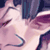 Pixelated static image of a character with closed eyes and flowing hair in pink/purple tones against dark background.