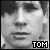 Black-and-white pixelated close-up of a person's face with bold text "TOM" in the bottom-right corner, displayed as a static buddy icon.