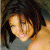 A pixelated image of a person with dark hair and light skin wearing a gray top, next to green text reading "Original Icons .com" on a solid background.
