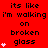 Red background with black text repeating 'its like i'm walking on broken glass' and pink heart symbols in a pattern, with some hearts animating in sequence