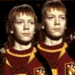 Two identical figures in maroon and gold uniforms with yellow lightning bolt accents stand side-by-side, their faces and backgrounds shifting between clear and faded states.
