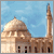 Pixelated image of a domed building with a tall minaret under a light blue sky with faint clouds.